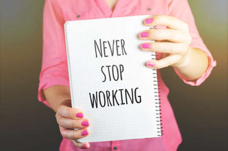 Young woman in pink shirt workingの写真素材