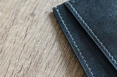 Leather wallet on wooden table
