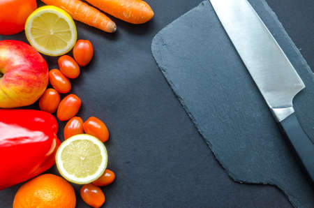 Healthy fresh fruits and vegetables on black table