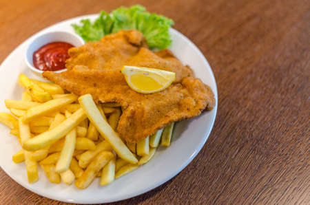Schnitzel with french fries and saladの写真素材