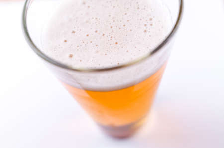 Beer glass full of foamの写真素材