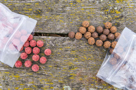 More species of fish lure presented in nature. Bait on wooden bridgeの写真素材