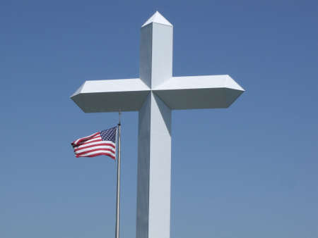 Large Cross with US Flag underneath and Blue sky backgroundの写真素材