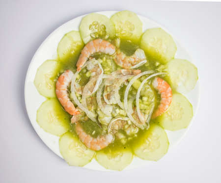 Prawns with cucumber and onion in white plate on white backgroundの写真素材