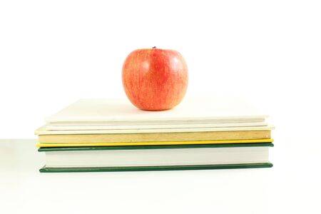 school books with apple back to school on white backgroundの写真素材