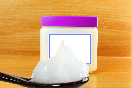 white petroleum jelly in spoon with jarの写真素材