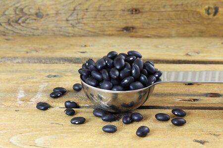 dry black beans in spoon