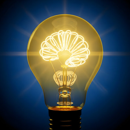 An illuminated light bulb on a dark blue background with a glowing brain inside.の素材