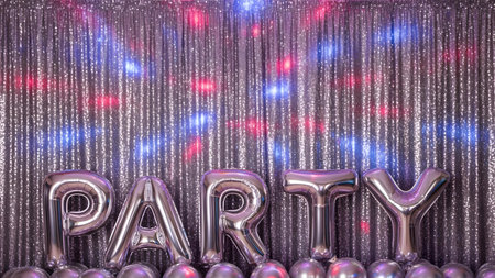 A vibrant party scene featuring silver foil balloons spelling PARTY in front of a sparkling silver tinsel curtain, illuminated by colorful disco lights creating a festive atmosphere.の素材