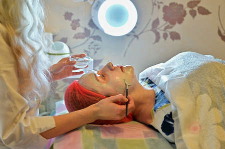 Photo of facial massage with hands and beautician brush. The concept of beauty
