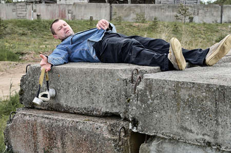 A man with a gas mask lies on the ruins. Biohazard concept. Environmental pollution, ecological disaster, radiationの写真素材