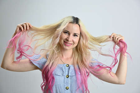 Horizontal portrait of a pretty caucasian woman with a wreath on her head. Blonde colored hair model smiling posing in studio on a white background.の写真素材
