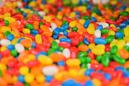 A large photo of multi-colored candies on a tray in a store, ready for sale.の写真素材