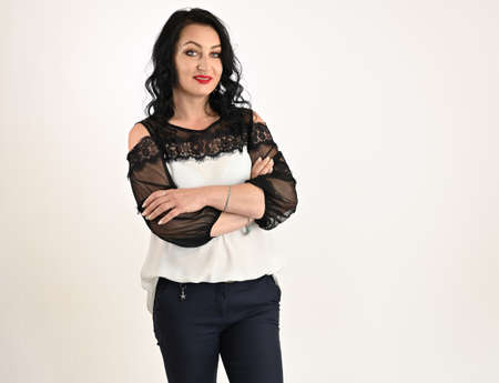 Portrait of a pretty model on a white background. Caucasian middle-aged brunette woman posing in studio.の写真素材
