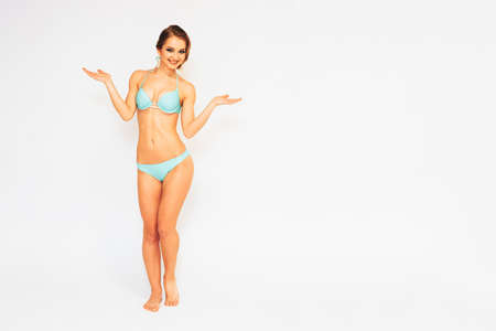 beautiful young girl in a swimsuit on a white isolated backgroundの写真素材