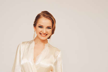 beautiful sweet girl in a silk dressing gown  in different posesの写真素材