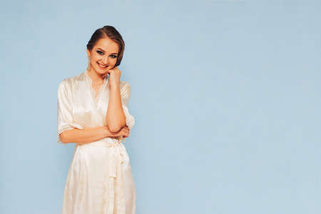 beautiful sweet girl in a silk dressing gown  in different posesの写真素材