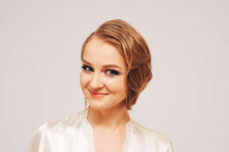 beautiful sweet girl in a silk dressing gown  in different posesの写真素材