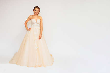 beautiful young bride in a wedding dress demonstrates different posesの写真素材