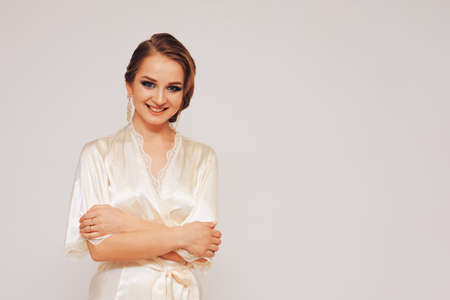 beautiful sweet girl in a silk dressing gown  in different posesの写真素材