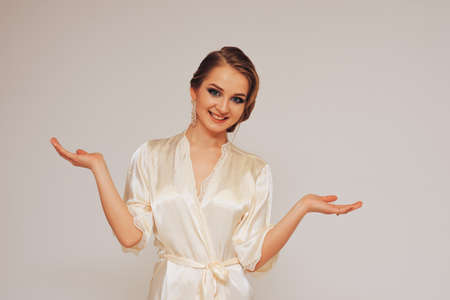 beautiful sweet girl in a silk dressing gown  in different posesの写真素材