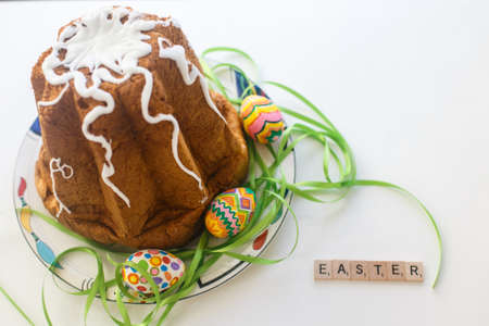 Easter cake and colored eggs with green ribbonの写真素材