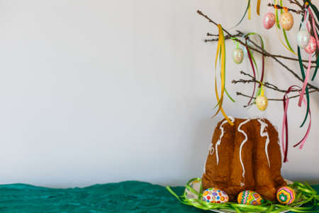 Easter cake with easter eggs and branch with ribbons on the white backgroundの写真素材