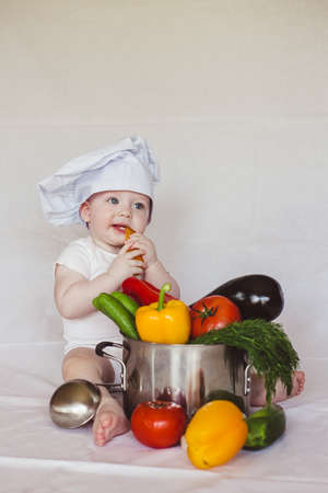 Healthy nutrition Happy little boy in hat prepares a vegetable salad. Cookの写真素材