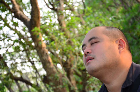 Pleasure by Nature---An office guy set off his mind in the middle of nature, free from all chaos in the city. He looks peacfulの写真素材