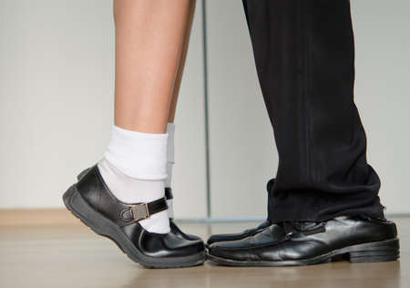 A couple with a different age and height is facing each other.の写真素材