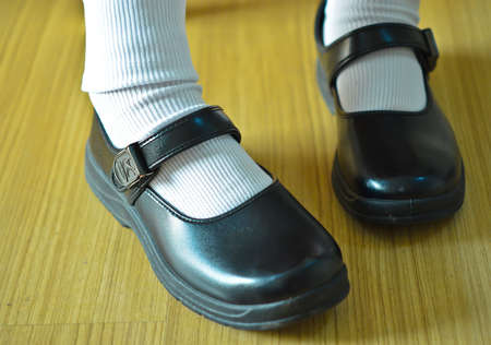 Thai girl wears a black leather shoes as a school uniform. の写真素材