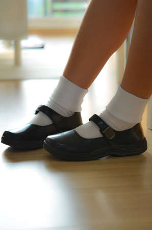 Thai girls wear a black leather shoes as a school uniform.の写真素材