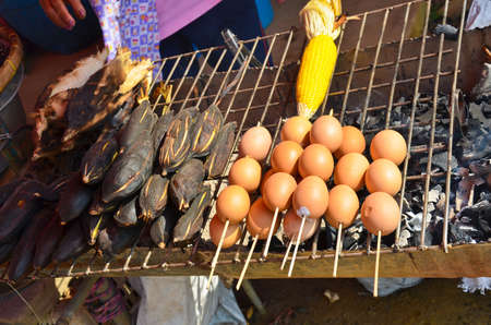 Grilled egg and potato in Thai rural marketの写真素材