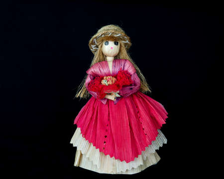 A woman doll, made of corn peel with black isolation backgroundの写真素材