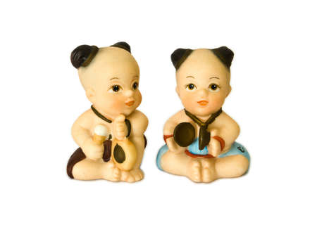 Thai medieval children doll playing native music with white isolated background.の写真素材