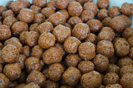 Pile of choco balls cereal in white backgroundの写真素材