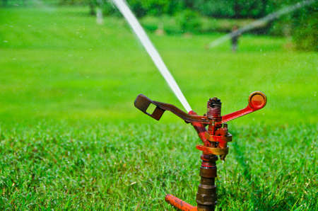 A metal automatic water sprinkler in the vast fieldの写真素材