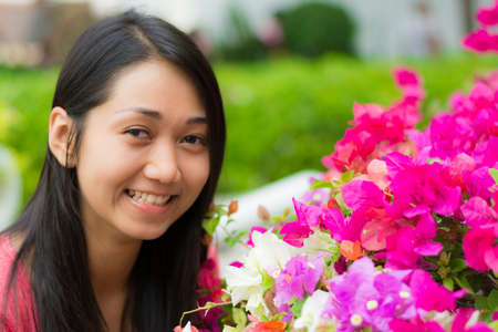 Cute Thai girl is very happy with flowers. の写真素材