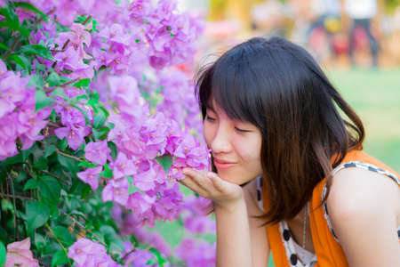 Cute Thai girl scent a purple Kertas. She loves flowers.の写真素材