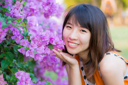 Cute Thai girl is very happy with purple Kertas. She is smiling with joy.の写真素材