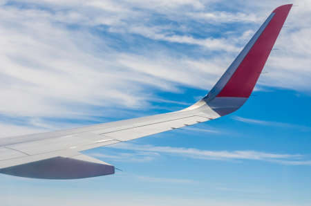 Aeroplane wings in the blue skyの写真素材