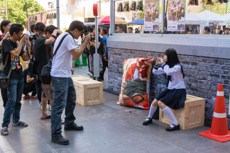 BANGKOK, THAILAND - MARCH 31: Cute Thai cosplayer dresses as Japanese schoolgirl posing for men photographer in 3rd Thai-Japan anime festival on March 31, 2013.のeditorial素材
