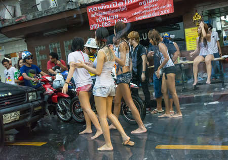 BANGKOK, THAILAND  - 12 APRIL 2013: Wild chicks and transvestite blocking cars on street in Songkran on April 12, 2013. Songkran is a festival which people can splash water freely in Thailand.のeditorial素材