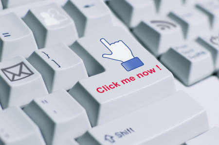 A finger sign saying  click me now  on the keyboard  This is fully social media era の写真素材