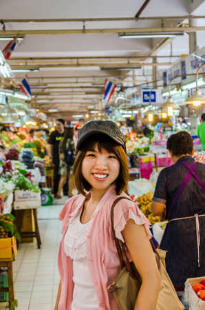 Active Asian girl tourism is touring in Thailand open marketの写真素材