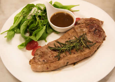 Premium ribeye steak on a well decorated dish ready to serveの写真素材
