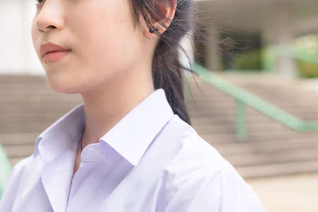 Neck occiput and body parts of Asian Thai high schoolgirls student in school uniform with white shirt education fashion and wind blowing conceptの写真素材