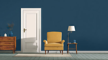 An inviting interior scene showcases a yellow armchair and a table lamp set against a deep blue wall. A white door and a wooden chest of drawers complete the setting. The lighting appears soft, suggesting an indoor environment. This image could be used for a variety of design and lifestyle publications.の素材