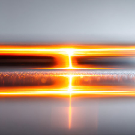 This abstract image presents glowing horizontal lines in hues of orange and yellow against a gray backdrop. The composition suggests motion and energy, with blurred streaks and a diffused lighting effect. It may be suitable for illustrating concepts of technology, data, or digital effects for various commercial applications.の素材