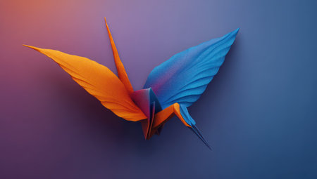 An origami-style bird is displayed with contrasting orange and blue wings. The image showcases a smooth gradient backdrop with a modern, artistic style. This vibrant illustration may be suitable for creative projects, design layouts, and various editorial content. The image has a clean aesthetic and could be used for print and digital purposes.の素材